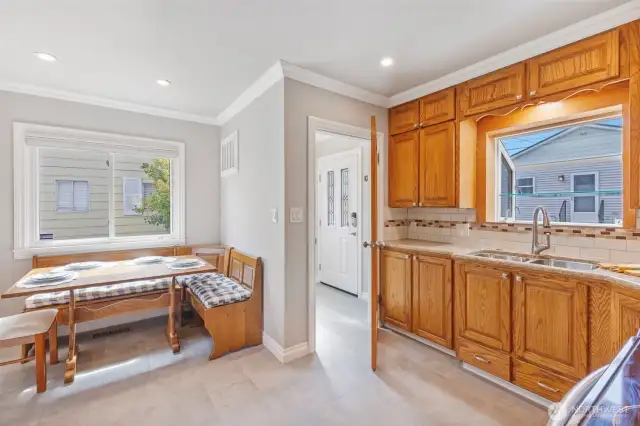 The kitchen has dining nook that stays and custom cabinets including functional drawers under the sink. Also off the kitchen is a small mudroom.