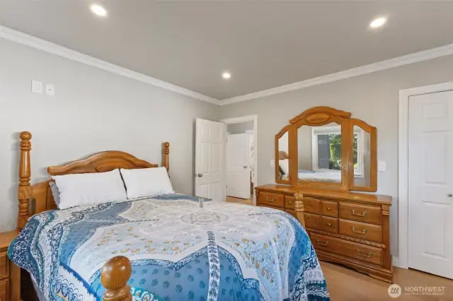 Another view of the primary bedroom including outlets for a wall mount tv.