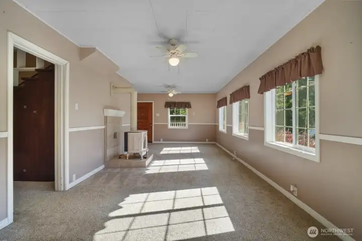 View from dining room looking at front door, hallway to 2nd living room on left, plenty of light!