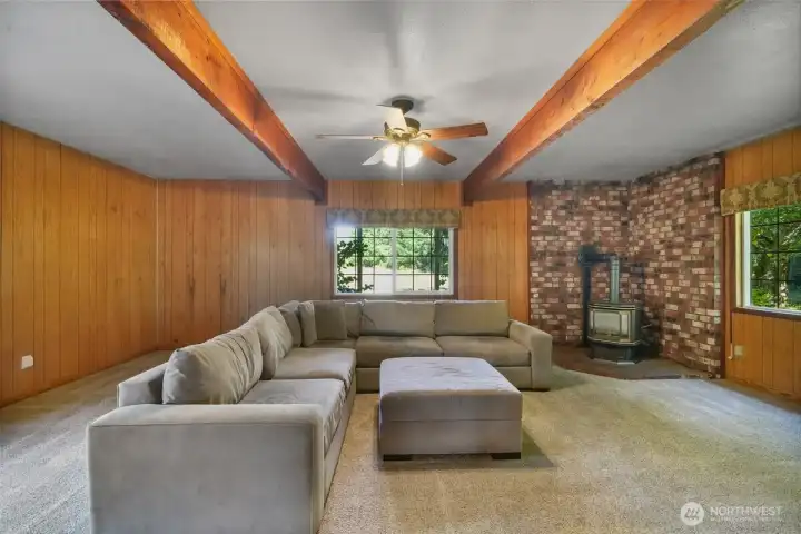2nd living room with big wood beams and access to the trex deck, backyard, patio, garage, shop, barn, fruit trees