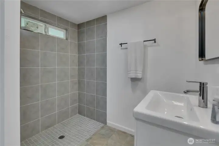 Master bathroom with large new shower and new sink.