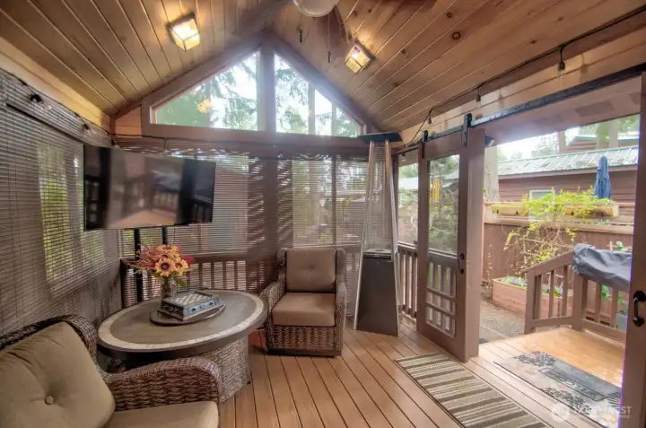 FRONT 11 X 13 PORCH SCREENED IN THE TV, FIRE TABLE, CHAIRS AND SLIDING BARN DOORS