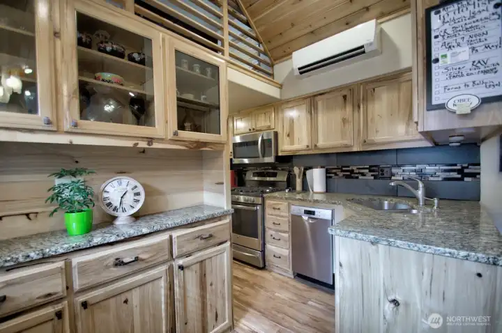 KITCHEN WITH GRANITE COUNTER TOPS, DISHWASHER, PROPANE STOVE, UNDER MOUNT SINK. REFRIGERATOR WITH ICE MAKE ALL STAINLESS STEELE