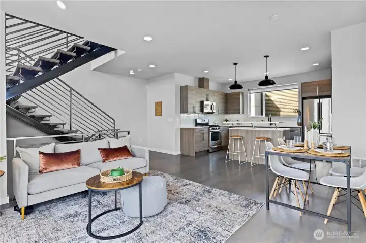 Living area with large windows and hardwood floors