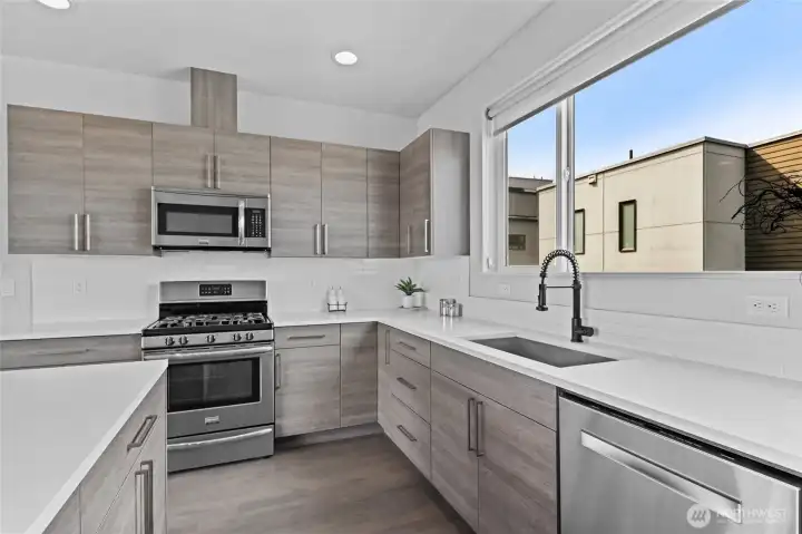 Kitchen with quartz counters and stainless appliances