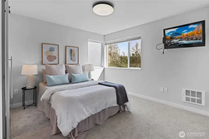 Spacious primary bedroom with natural light