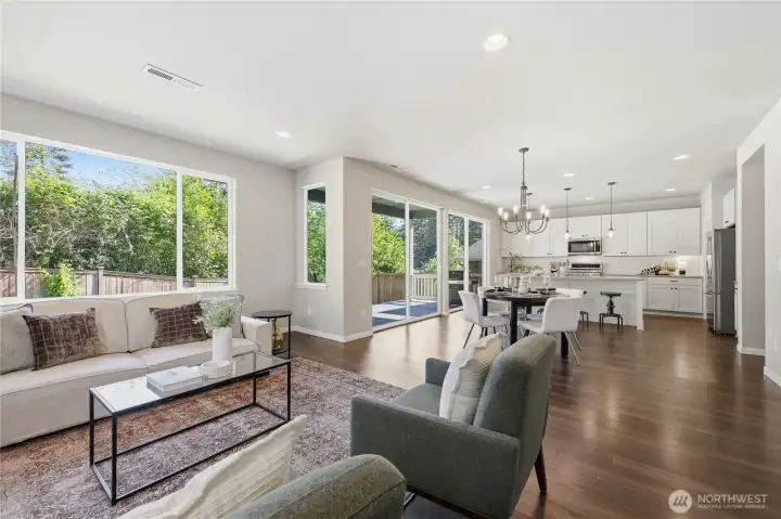 Beautiful floors and expansive windows fill this open-concept home with natural light, creating a warm and inviting atmosphere perfect for everyday living and entertaining. Beautiful floors and expansive windows fill this open-concept home with natural light, creating a warm and inviting atmosphere perfect for everyday living and entertaining.