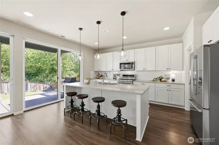 Two expansive sliding doors seamlessly connect the indoor living space to the covered back patio and yard. Two expansive sliding doors seamlessly connect the indoor living space to the covered back patio and yard.