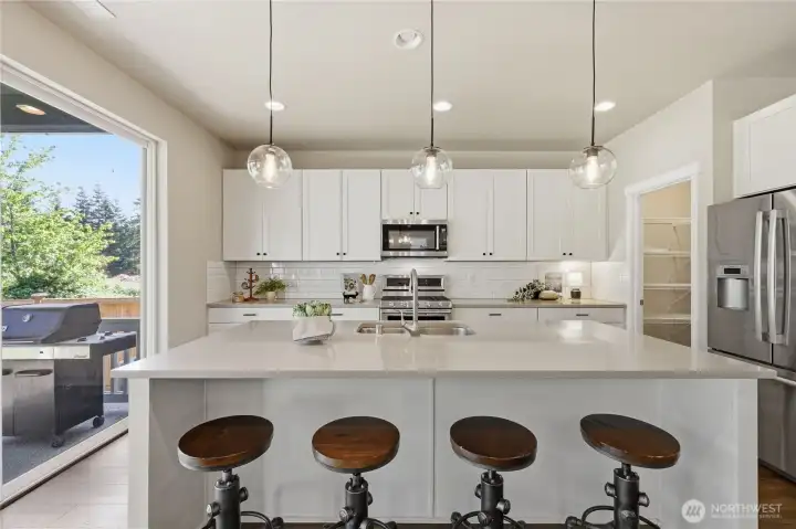 The kitchen showcases beautiful light cabinetry, stylish finishes, and modern lighting, creating a bright and contemporary space that is both functional and inviting. The kitchen showcases beautiful light cabinetry, stylish finishes, and modern lighting, creating a bright and contemporary space that is both functional and inviting.