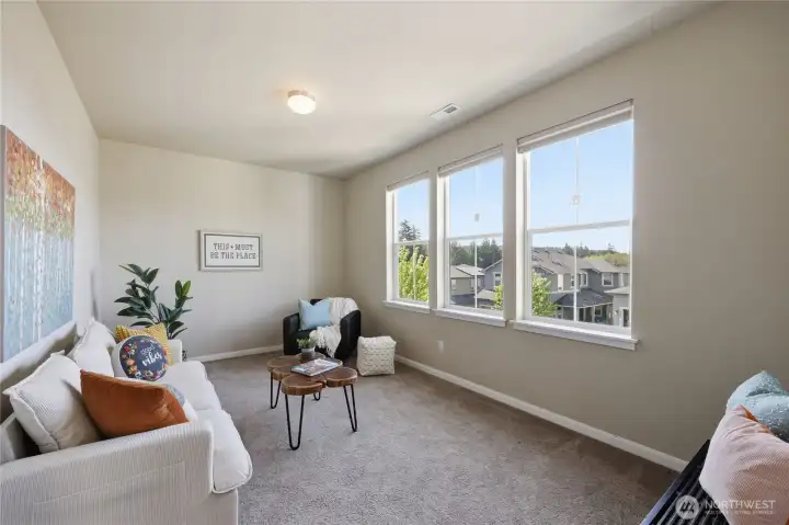 At the top of the stairs, a spacious family room/loft provides the perfect flex space for a media room, play area, or additional lounge space. At the top of the stairs, a spacious family room/loft provides the perfect flex space for a media room, play area, or additional lounge space.