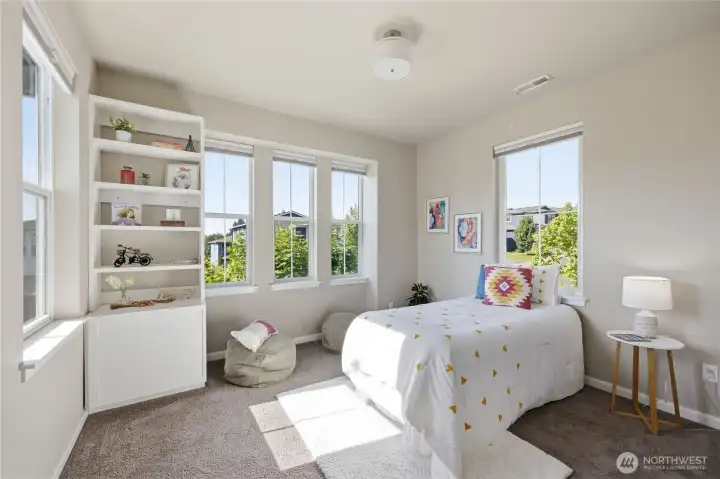 Bedroom number three boasts a ton of natural light as well, along with a closet and a built-in shelf. Bedroom number three boasts a ton of natural light as well, along with a closet and a built-in shelf.