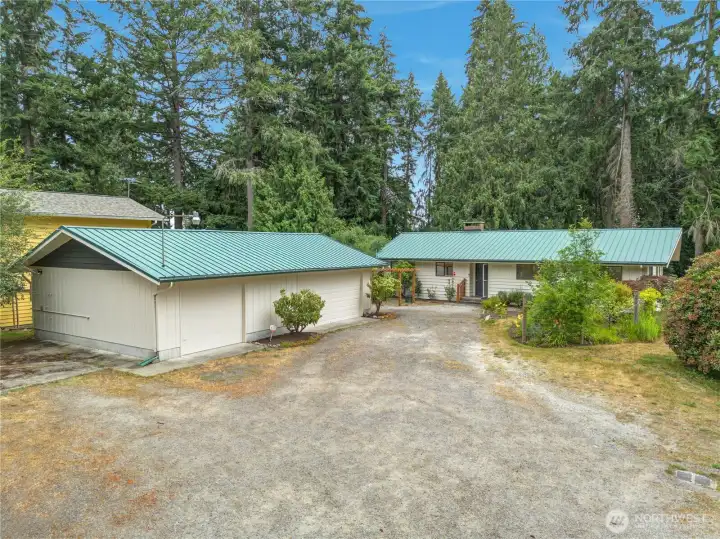 3 beds with 2 den (5 bedroom home on 3 bedroom septic) with detached shop on shy 1/2 an acre.