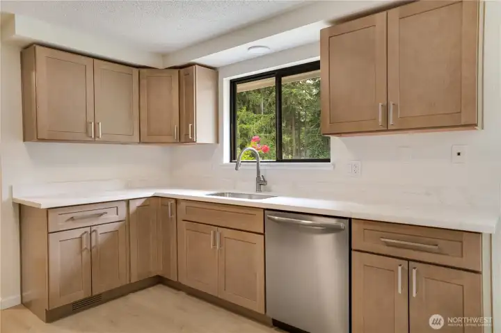 Brand new kitchen on the main floor. Quartz Countertops, new LVP flooring & SS appliances