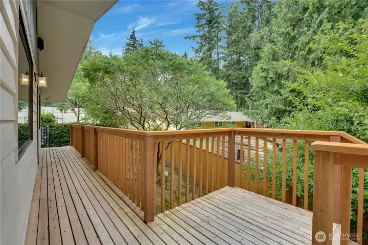 Beautiful new, wrap around cedar deck with stairs to the lower level backyard and Lowe patio