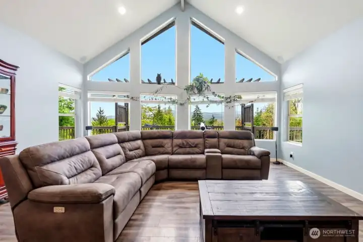 Open living room, just inside the entry with a wall of windows to take in your mountain views
