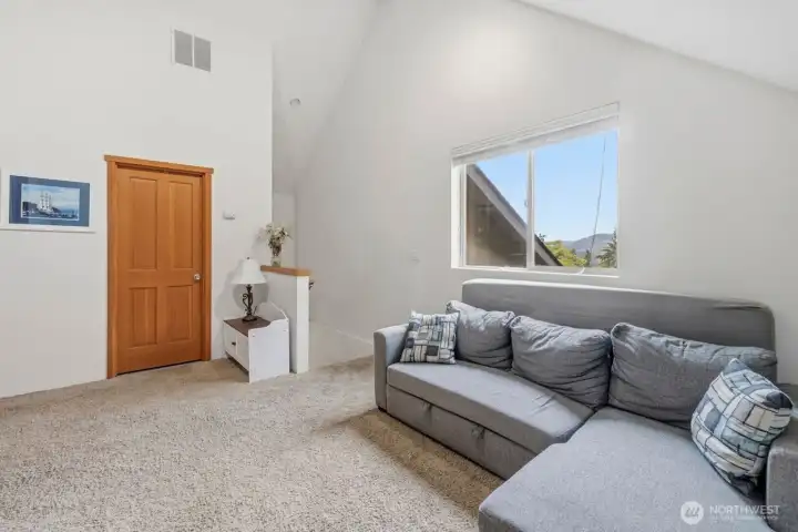 Upstairs loft off kitchen with entertaining room, full bathroom and two additional rooms that could be used as an office or bedrooms