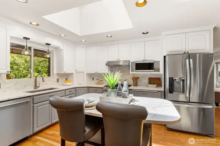 Beautifully updated kitchen with skylights, calming colors and room to creat