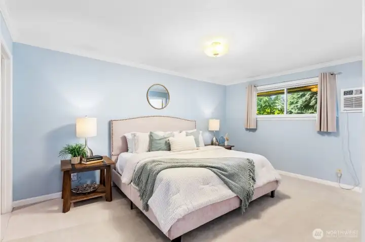 Main floor primary bedroom is peaceful and serene