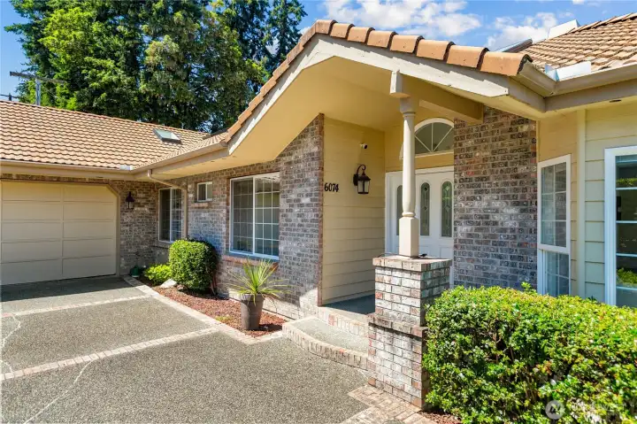 Beautiful home with Tile Roof and brick entry way.