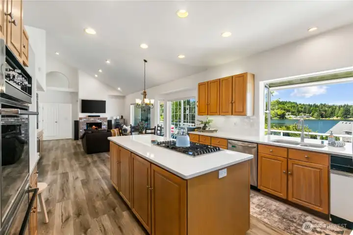 Kitchen with oversided island quartz counters with tile backsplash all new.