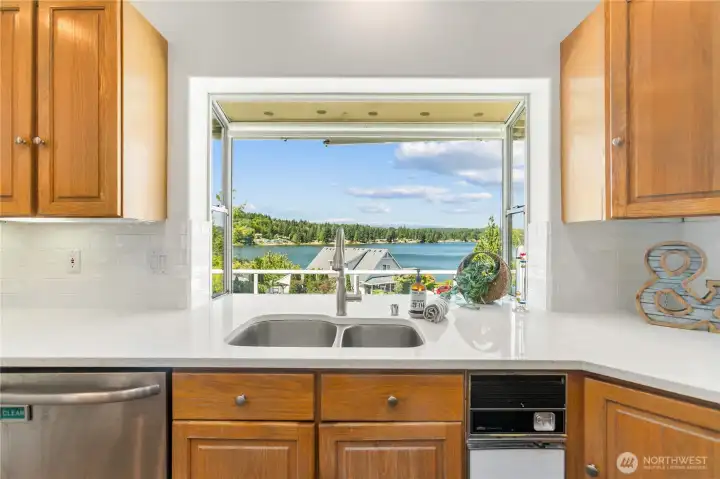 Your view from  your kitchen window, new dishwasher, garbage compactor and window that brings so much light into the kitchen.