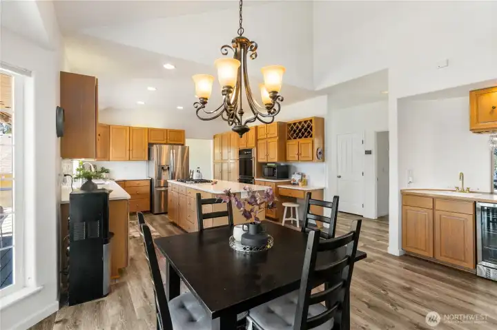 Dining between family room and kitchen, wet bar with refrigerator, new vinyl flooring.  So much storage.