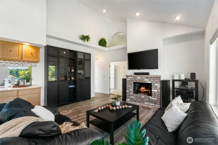 The sooring ceilings with beautiful lighting makes this family room a place you will gather for your events or holidays.
