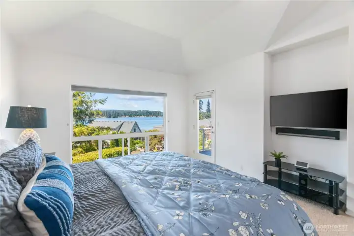 The primary suite has vaulted ceilings, View of the Lake and a door to the deck.  The King bed takes up a small area.  This suite is perfect for watching TV, reading and watching the Lake & Mountain view.