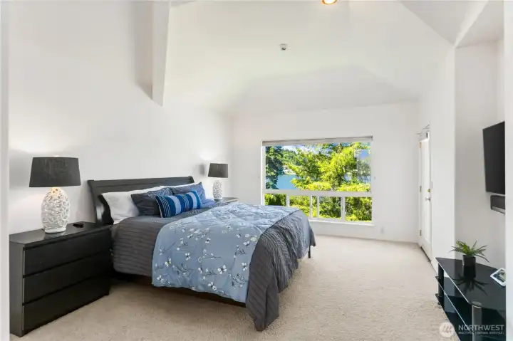 The vaulted ceilings and Lake views with door to outside deck add style and a feeling of being in a much larger home.