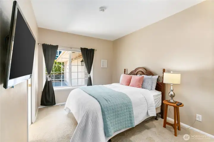 Guest bedroom that has separate entrance to the main bath which has a door separating the shower from the sink and toilet.