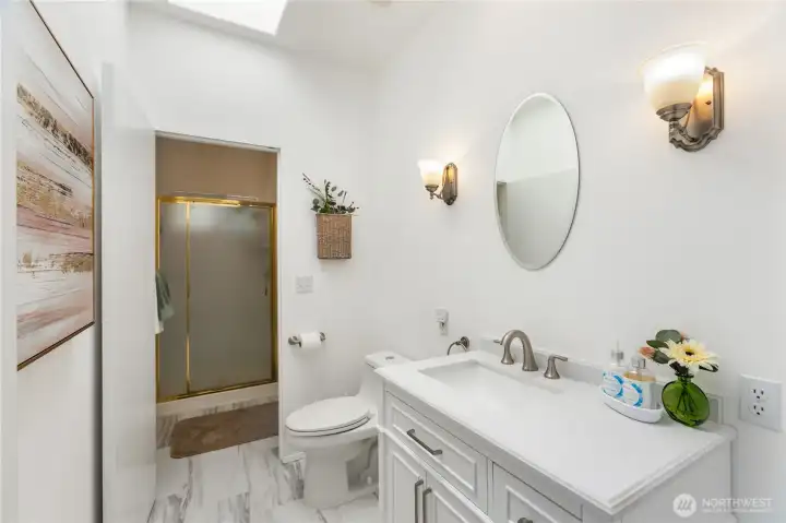 Main bath with Double Shower door the shuts off the shower area that opens to the guest room.
