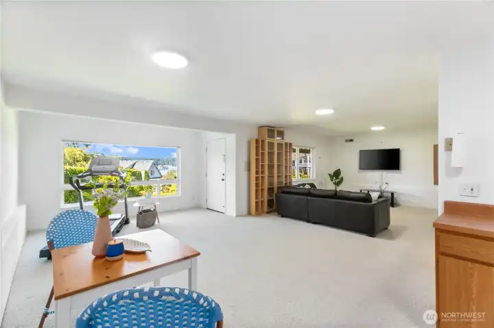 Another large window with views of the lake and beautiful landscaping.  Plenty of room for guests, or other members of the household that may need a separate living space.  Door to outside.