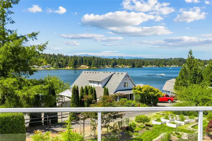 Deck looks down onto neighbors landscaping while you enjoy the lake view and plants and flowers you don't have to take care of.