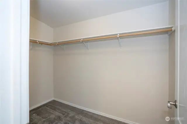 Spacious walk-in closet in the primary suite, offering ample storage.