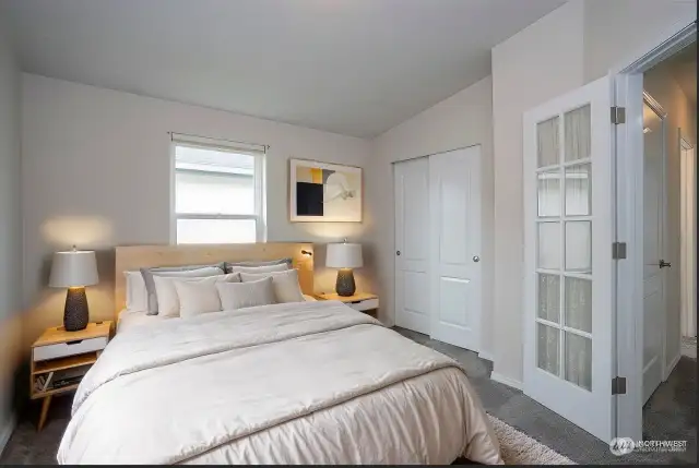 * Virtual Staged * The third guest suite, which can also serve as an office or den, is located at the front of the home. French doors add a touch of elegance and versatility to the space.