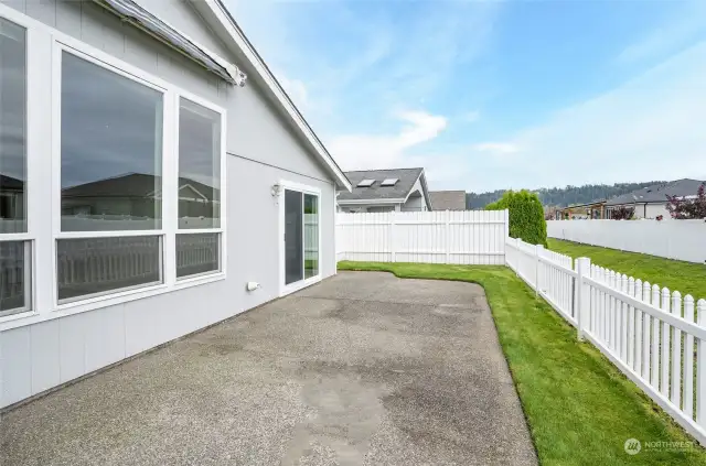 Here’s another great view of the patio, with the sliding door to the left leading directly to the primary suite at the back of the home.