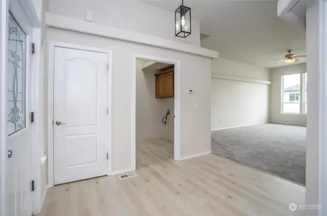 As you enter, your view extends into the inviting living area just beyond. To the left, you'll find the utility room, complete with additional cabinets and a convenient utility sink.