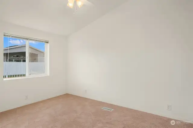 On the opposite side of the home from the primary suite sits this bedroom with adjacent full bath.