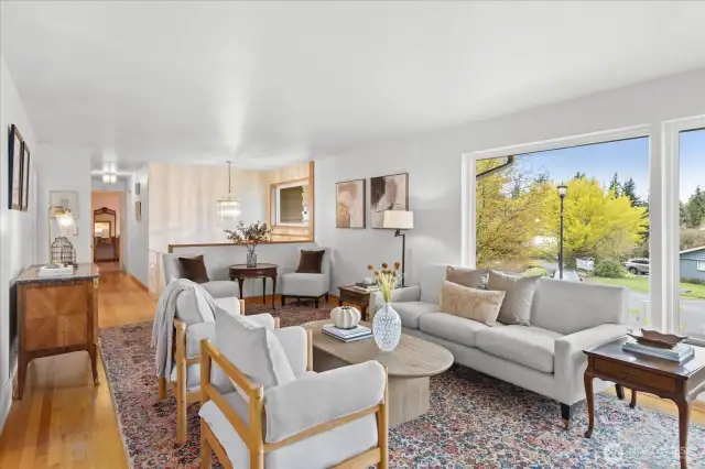 Large windows fill the living room with natural light.