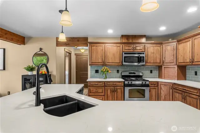 Kitchen with expansive island, dual sink, and open view to living room.