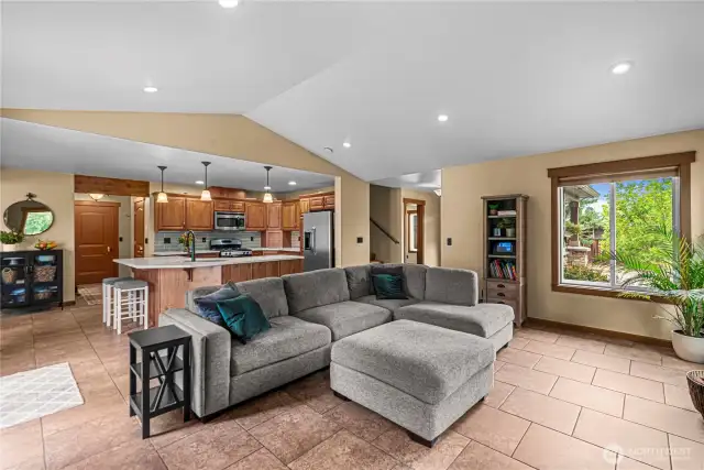 Inviting living room with stone fireplace, natural light, and open layout.