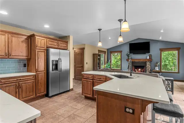 Kitchen with expansive island, dual sink, and open view to living room.