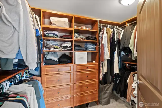 Spacious walk-in closet with built-in shelving and ample storage.