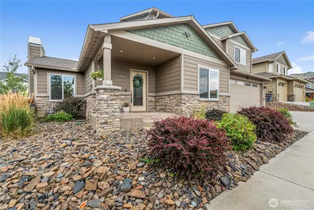 Low-maintenance landscaping with welcoming entry and nearby walking sidewalks.