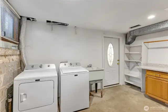 Downstairs utility and laundry room that can be shared with both upstairs unit and downstairs unit. The door in the background is the other entrance to the lower unit.