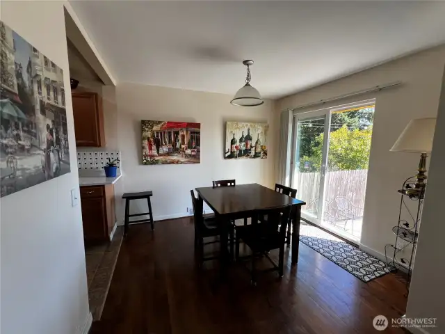 Experience Seamless Indoor/Outdoor Living with Glass Door Opening to Front Yard from Dining Area.