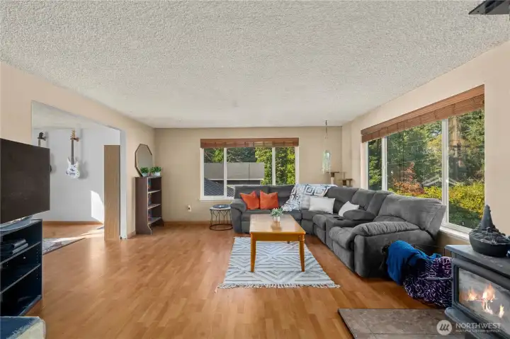Large windows line the back wall, inviting in abundant daylight and offering tranquil outdoor views. The spacious footprint accommodates oversized furniture or multi-use layouts