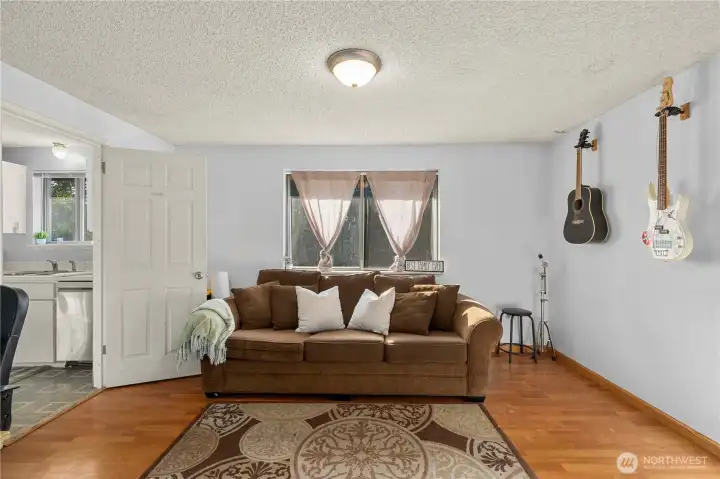 This versatile room just off the kitchen offers endless possibilities — originally designed as a formal dining area, it easily adapts as a home office, music room, or secondary sitting space. Natural light from the window creates a bright and comfortable setting, ideal for work or relaxation.