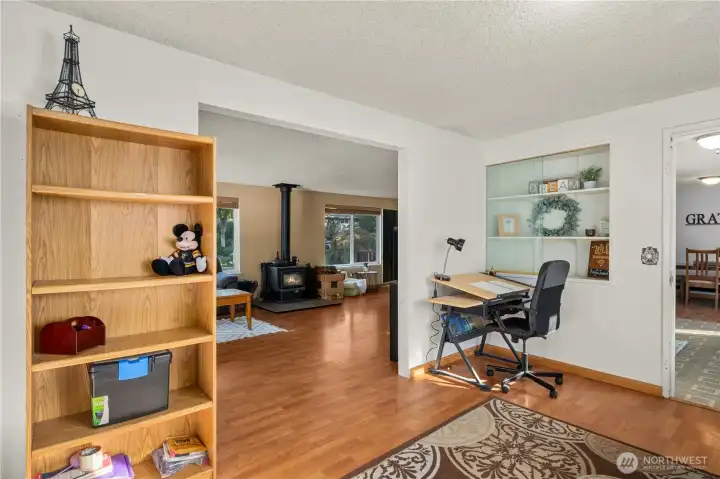 Open to the main living area, this flexible room connects seamlessly with the home’s central spaces while maintaining its own privacy. Built-in shelving adds function and character, making it perfect for creative use — from a homework zone or art studio to a cozy den for multigenerational living needs.
