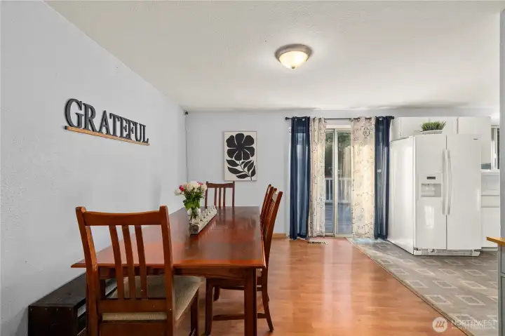 Large eat-in dining area with direct access to the deck via sliding doors—great flow for everyday meals and larger gatherings.